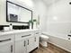 Modern bathroom with white vanity, black accents, and decorative backsplash at 606 E Pearsall St, Dunn, NC 28334