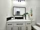 Elegant bathroom with black hardware, and a well-lit mirror at 606 E Pearsall St, Dunn, NC 28334