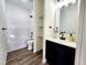Stylish bathroom featuring shower, toilet, and vanity with black hardware at 606 E Pearsall St, Dunn, NC 28334