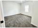 Bedroom with soft carpeting and natural light from a window at 606 E Pearsall St, Dunn, NC 28334