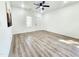 Bright and airy bedroom with wood-look flooring, white walls, and a window view at 606 E Pearsall St, Dunn, NC 28334