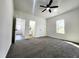 Bright bedroom features neutral carpet, ceiling fan, and ample natural light at 606 E Pearsall St, Dunn, NC 28334