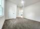 Clean bedroom with carpeted floors, bright windows, and neutral walls at 606 E Pearsall St, Dunn, NC 28334