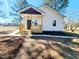 Charming single-story home featuring a cozy front porch and freshly landscaped yard at 606 E Pearsall St, Dunn, NC 28334