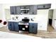 Modern kitchen with gray cabinets, stainless steel appliances, white countertops, and wood-look flooring at 606 E Pearsall St, Dunn, NC 28334