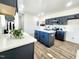 Modern kitchen view with an island, grey cabinets, stainless steel appliances, and an open floorplan at 606 E Pearsall St, Dunn, NC 28334