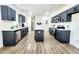 Spacious kitchen with an island, modern appliances, grey cabinetry, and an open floorplan at 606 E Pearsall St, Dunn, NC 28334
