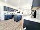 Modern kitchen featuring stainless appliances, island, sleek cabinetry and wood flooring at 606 E Pearsall St, Dunn, NC 28334
