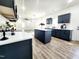 Modern kitchen with stainless appliances, an island, sleek cabinetry and wood flooring at 606 E Pearsall St, Dunn, NC 28334