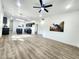 Open living room with modern furnishings, wood-look flooring, and a view into the kitchen at 606 E Pearsall St, Dunn, NC 28334