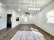 Bright living room featuring a modern light fixture and wood-style floors at 606 E Pearsall St, Dunn, NC 28334