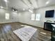 Open living room with modern furnishings, wood-look flooring, and a view into the kitchen at 606 E Pearsall St, Dunn, NC 28334
