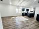Open living room with modern furnishings, wood-look flooring, and a view into the kitchen at 606 E Pearsall St, Dunn, NC 28334
