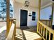 A welcoming porch featuring fresh wood and a modern light fixture at 606 E Pearsall St, Dunn, NC 28334