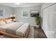 Light-filled bedroom with a wooden bed frame and a closet at 623 Sybil Dr, Durham, NC 27703