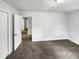 Bedroom featuring neutral carpet, bright window, and walk-in closet at 623 Sybil Dr, Durham, NC 27703