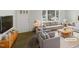 Bright, staged living room with large window and neutral tones at 623 Sybil Dr, Durham, NC 27703