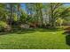 Lush backyard with an expansive lawn and mature trees, offering a private and serene outdoor space at 6504 Brandywine Rd, Raleigh, NC 27607