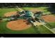 Aerial shot of well-maintained baseball/softball fields with covered seating areas, perfect for sports enthusiasts at 7025 Dayton Ridge Dr, Apex, NC 27539