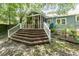 Home's backyard with a deck surrounded by the natural beauty of mature trees at 816 Carolina Ave, Durham, NC 27705