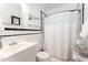 Cozy bathroom featuring white tile, black trim, and a shower with curtain at 816 Carolina Ave, Durham, NC 27705