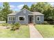 Charming single story home with a manicured front lawn, walkway, and beautiful landscaping at 816 Carolina Ave, Durham, NC 27705