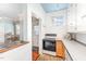 Well-lit kitchen area with tiled backsplash, modern appliances, and seamless flow to dining at 816 Carolina Ave, Durham, NC 27705