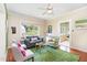 Cozy living room with ample natural light, stylish furnishings, and wood floors at 816 Carolina Ave, Durham, NC 27705
