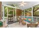 Relaxing screened in porch with a ceiling fan, wicker furniture, and comfortable bench at 816 Carolina Ave, Durham, NC 27705