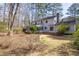 Backyard featuring a home with a chimney and a grassy lawn at 816 Churchill Dr, Chapel Hill, NC 27517
