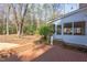 Brick patio with a screened-in porch and steps leading to the backyard at 816 Churchill Dr, Chapel Hill, NC 27517