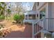 Backyard featuring a brick patio, screened in porch, and stairs at 816 Churchill Dr, Chapel Hill, NC 27517