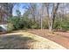 Spacious backyard featuring a mix of trees, shrubs, and a well-maintained lawn for outdoor enjoyment at 816 Churchill Dr, Chapel Hill, NC 27517