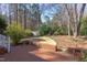 Brick patio with a view of a grassy backyard and a storage shed at 816 Churchill Dr, Chapel Hill, NC 27517