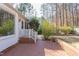 Brick patio leading to a lush backyard, perfect for outdoor entertaining at 816 Churchill Dr, Chapel Hill, NC 27517