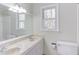 Bathroom featuring a double sink vanity with a window for natural light at 816 Churchill Dr, Chapel Hill, NC 27517