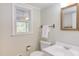 Bright bathroom features a vanity, mirror, and a window for natural light at 816 Churchill Dr, Chapel Hill, NC 27517