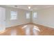 Cozy bedroom featuring hardwood floors, natural light, and a ceiling fan for added comfort at 816 Churchill Dr, Chapel Hill, NC 27517