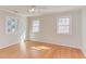 Bright bedroom with hardwood floors, three windows, and a ceiling fan at 816 Churchill Dr, Chapel Hill, NC 27517