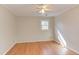 Comfortable bedroom with hardwood floors, a ceiling fan, and a window offering natural light at 816 Churchill Dr, Chapel Hill, NC 27517