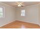 Sunny bedroom with hardwood floors, a ceiling fan, and windows allowing for bright, natural light at 816 Churchill Dr, Chapel Hill, NC 27517