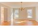 Dining room featuring hardwood floors, a chandelier, and natural light at 816 Churchill Dr, Chapel Hill, NC 27517