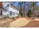 Side view of a two-story home with a brick walkway and lush landscaping at 816 Churchill Dr, Chapel Hill, NC 27517