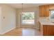 Eat-in kitchen with hardwood floors, a chandelier, and a large window at 816 Churchill Dr, Chapel Hill, NC 27517