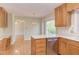 Bright kitchen with wood cabinets, island, dishwasher, and hardwood floors at 816 Churchill Dr, Chapel Hill, NC 27517