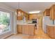 Sunlit kitchen featuring wood cabinetry, stainless steel appliances, hardwood floors at 816 Churchill Dr, Chapel Hill, NC 27517