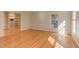 Spacious living room with hardwood floors, a built-in bookshelf, and natural light at 816 Churchill Dr, Chapel Hill, NC 27517