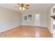 Spacious living room with hardwood floors, lots of light, and door to outside at 816 Churchill Dr, Chapel Hill, NC 27517