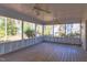 Relaxing screened-in porch with wood floors and ceiling fans, perfect for enjoying the outdoors at 816 Churchill Dr, Chapel Hill, NC 27517