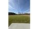 Large, grassy backyard with open field and view of the sky at 90 Pate Landing Dr, Selma, NC 27576